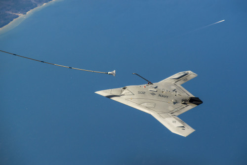 US Navy's X-47B, AV-2, Bureau # 168064, of Air Test and Evaluation Squadron Two Three (VX-23), conduct Astern PD (Probe Drogue) Buildups, Missed Engagements, and Astern PD Offsets with the Omega Tanker over the Chesapeake Bay on 11 April 2015.  VX-23 is p