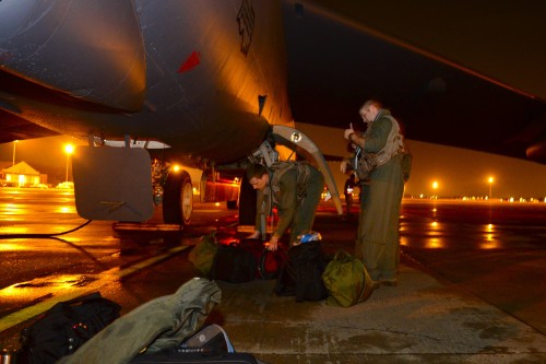 Members of the 96th Bomb Squadron load their equipment onto a B-52H Stratofortress on Barksdale Air Force Base, La. June 30, 2015. Before takeoff, the aircrew review the mission and procedures for ground checks. (U.S. Air Force photo/Senior Airman Benjamin Raughton)