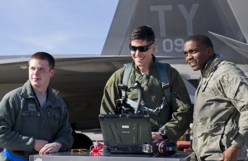 Major Scott Crowell, 325th Operations Group F-22 Raptor pilot, Senior Airmen Eric Woods, 95th Aircraft Maintenance Unit crew chief and Senior Airman Brandon Hortman, 95th AMU avionics specialist, talk on the flightline during the first day of Red Flag 16-1, Jan. 25, at Nellis AFB, Nev. Tyndall Airmen are honing their skills with three weeks of exercise training alongside squadrons from around the world.