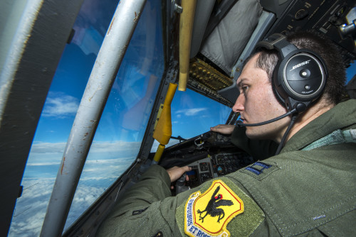 U.S. Air Force Capt. Christopher Thompson, 909th Air Refueling Squadron KC-135 Stratotanker pilot, scans the horizon for other aircraft during Forceful Tiger Jan. 28, 2016, near Okinawa, Japan. The 909th ARS, which is charged with supplying fuel to other aircraft in flight, delivered a total of 1.3 million pounds of fuel to more than 130 aircraft during the large force exercise. (U.S. Air Force photo by Staff Sgt. Maeson L. Elleman)