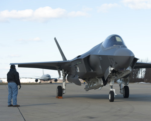 160205-O-ZZ999-924 NAS Patuxent River (February 5, 2016) A member of the Pax River Integrated Test Force (ITF) stands at the ready as Italian Air Force (Aeronautica Militare) aircraft AL-1 — the first F-35 Lightning II international jet fully built overseas at the Cameri Final Assembly & Check-Out (FACO) facility at Cameri Air Base, Italy — arrives at the Navy’s Electromagnetic Environmental Effects (EEE) test and evaluation laboratory aboard Naval Air Station (NAS) Patuxent River on Feb. 5, 2016. (U.S. Navy photo courtesy Andy Wolfe/Released)