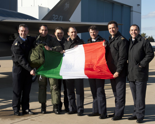 160205-O-ZZ999-955 NAS Patuxent River (February 5, 2016) Italian Air Force (Aeronautica Militare) personnel celebrate after an F-35A Lightning II aircraft made aviation history by completing the very first F-35 trans-Atlantic Ocean crossing, arriving at Naval Air Station Patuxent River, Md., from Cameri Air Base, Italy, on Feb. 5 at 2:24 p.m. EST. F-35A aircraft AL-1, the first international jet fully built overseas at the Cameri Final Assembly & Check-Out (FACO) facility at Cameri Air Base, Italy, is also the first F-35 assembled outside of the U.S. to land on U.S. soil.  (U.S. Navy photo courtesy Andy Wolfe/Released)