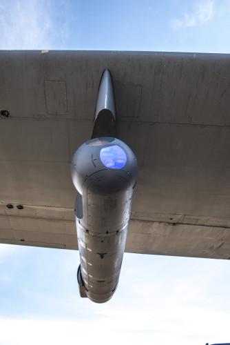A Northrop Grumman LITENING pod targeting system is mounted on the wing of a 189th Airlift Wing C-130H. The Arkansas Air National Guard has been tapped by the Air National Guard Air Force Reserve Test Center (AATC) to provide a test bed for a new highly-accurate air drop and reconnaissance system.