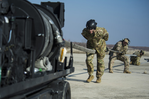 Airmen clear remaining fuel in a hose back into a forward area manifold cart during forward area refueling point training at Plovdiv, Bulgaria, Feb. 9, 2016. There are less than 60 Airmen across the entire Air Force qualified to conduct FARP training. (U.S. Air Force photo by Airman 1st Class Luke Kitterman/Released)