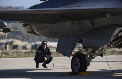 A U.S. Air Force crew chief assigned to the 480th Expeditionary Fighter Squadron aircraft maintenance unit, performs pre-flight inspections on an F-16 Fighting Falcon fighter aircraft assigned to the 480th EFS on the flightline during a flying training deployment at Souda Bay, Greece, Jan. 28. 2016. Crew chiefs perform pre-flight and secondary inspections of the aircraft before pilots taxi the aircraft to the flightline for takeoff. (U.S. Air Force photo by Staff Sgt. Christopher Ruano/Released)
