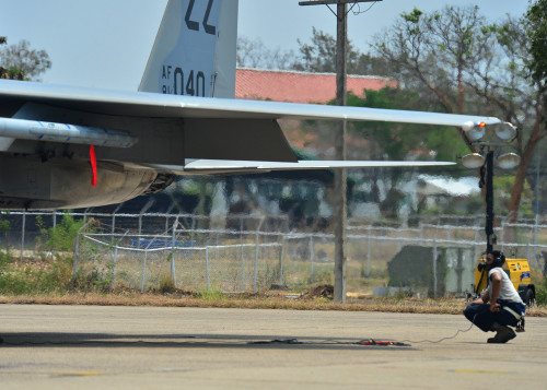 Senior Airman Isaiah Braxton, a crew chief for the 67th Fighter Squadron, Kadena Air Base Japan, observes the flight controls movement of an F-15 Eagle during Exercise Cope Tiger 16, on Korat Royal Thai Air Force Base, Thailand, March 7, 2016. Exercise Cope Tiger 16 includes over 1,200 personnel from three countries and continues the growth of strong, interoperable and beneficial relationships within the Asia-Pacific Region, while demonstrating U.S. capability to project forces strategically in a combined, joint environment. (U.S. Air Force Photo by Tech Sgt. Aaron Oelrich/Released)