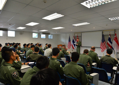 Lt. Col. Nicholas Register, the Director of Operations from 67th Fighter Squadron, Kadena Air Base, Japan, gives a mission briefing to pilots from the U.S. Air Force, Royal Thai Air Force, and the Republic of Singapore Air Force during Exercise Cope Tiger 16, on Korat Royal Thai Air Force Base, Thailand, March 8, 2016. Exercise Cope Tiger 16 includes over 1,200 personnel from three countries and continues the growth of strong, interoperable and beneficial relationships within the Asia-Pacific Region, while demonstrating U.S. capability to project forces strategically in a combined, joint environment. (U.S. Air Force Photo by Tech Sgt. Aaron Oelrich/Released)