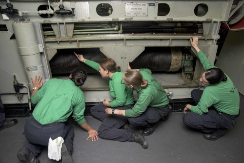 160319-N-KK394-092 ATLANTIC OCEAN (March 19, 2016) - Aviation Boatswain's Mate (Equipment) 2nd Class Spela Marinsek (center) inspects a catapult retraction engine aboard the aircraft carrier USS Dwight D. Eisenhower (CVN 69), the flagship of the Eisenhower Carrier Strike Group. Ike is underway conducting a Composite Training Unit Exercise (COMPTUEX) with the Eisenhower Carrier Strike Group in preparation for a future deployment. (U.S. Navy photo by Mass Communication Specialist 3rd Class Anderson W. Branch/Released)