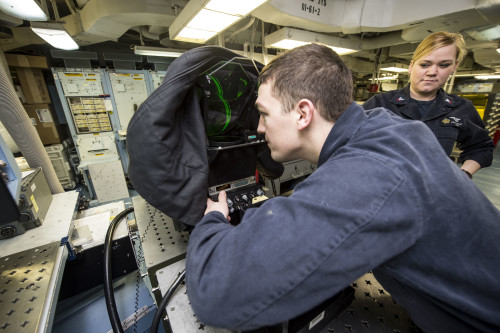 160320-N-BH414-021 ATLANTIC OCEAN (March 20, 2016) – Aviation Electronics Technician 3rd Class Zachary Conn looks into an aircraft heads-up display aboard the aircraft carrier USS Dwight D. Eisenhower (CVN 69), the flagship of the Eisenhower Carrier Strike Group. Ike is underway conducting a Composite Training Unit Exercise (COMPTUEX) with the Eisenhower Carrier Strike Group in preparation for a future deployment. (U.S. Navy photo by Mass Communication Specialist Seaman Apprentice Casey S. Trietsch/Released)