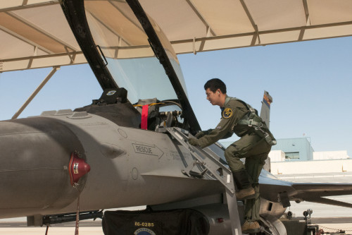 First Lt. Toshiaki Kawanishi climbs up into the cockpit of an F-16 Fighting Falcon during his pilot training at the Arizona Air National Guard’s 162nd Wing located at Tucson International Airport. “We cannot accomplish the mission with only one country,” said Kawanishi. “This is a good opportunity to learn about other nationalities and personalities, and to be able to apply that to the mission in the future.” (U.S. Air National Guard photo by 2nd Lt. Lacey Roberts)
