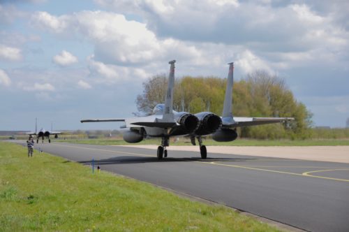 U.S. Air Force and Massachusetts Air National Guard public affairs officer 1st Lt. Bonnie Harper takes photos of F-15C Eagle aircraft taxing out for take-off during the Royal Netherlands Air Force Frisian Flag 2016 exercise, Leeuwarden Air Base, Netherlands, April 18, 2016. More than 70 aircraft and several hundred personnel from the United States, Netherlands, Belgium, France, Finland, Poland, Norway, United Kingdom, Germany and Australia are taking part.