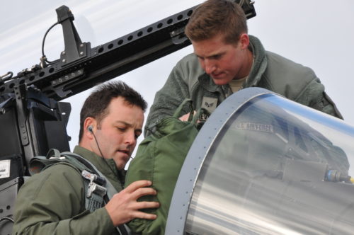 U.S. Air Force and Massachusetts Air National Guard Senior Airmen Benjamin Devoie hands flight equipment to Maj. Brett “Dutch” Vanderpas, an F-15C Eagle pilot, as he makes pre-flight preparations, April 20, 2016. Both are members of the 131st Expeditionary Fighter Squadron, which is deployed to Europe as part Operation Atlantic Resolve, and is currently participating in the Royal Netherlands Air Force Frisian Flag 2016 exercise, Leeuwarden Air Base, Netherlands.