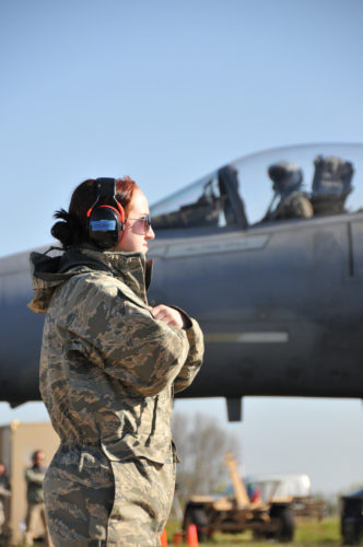 U.S. Air Force and Massachusetts Air National Guard Airman 1st Class Sarah Stec signals the pilot of an F-15C Eagle aircraft to hold and wait to taxi as another F-15C taxis by, April 21, 2016.  Airman 1st Class Stec is deployed to Leeuwarden Air Base, Netherlands, with the 131st Expeditionary Fighter Squadron and is currently participation in the Frisian Flag 2016 exercise. The exercise runs from April 11-22 and is comprised of more than 70 aircraft and several hundred personnel from the United States, Netherlands, Belgium, France, Finland, Poland, Norway, United Kingdom, Germany and Australia.