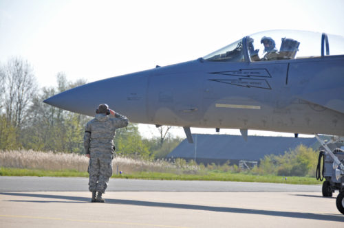 U.S. Air Force and Massachusetts Air National Guard crew chief salutes F-15C Eagle pilot as he embarks on a mission during Frisian Flag 2016. The Royal Netherlands Air Force exercise is designed to foster military cooperation between participating nations and these types of exchanges help establish trust and relationships, April 21, 2016.