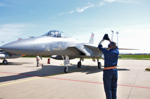 U.S. Air Force and Massachusetts Air National Guard crew chief marshals an F-15C Eagle aircraft during Frisian Flag 2016. The Royal Netherlands Air Force exercise is designed to foster military cooperation between participating nations and these types of exchanges help establish trust and relationships, April 21, 2016.