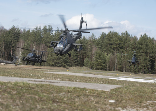 Two AH-64 Apache helicopters (left and middle) from 1st Battalion, 3rd Aviation Regiment, 12th Combat Aviation Brigade and one German Tiger Attack helicopter (right) from 4th Battalion, Kampfhubschrauberregiment 36, Fritzlar, Germany, take off from the forward arming and refueling point (FARP). The 1st Bn., 3rd Avn. Regt., recently completed their combined combat aerial gunnery from March 16-April 05, at the Grafenwoehr Training Area, Germany. (U.S. Army photo by Sgt. Thomas Mort, 12th CAB)