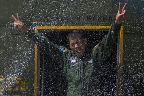 Japanese Air Defense Force Chief Master Sgt. Takanori Konishi, with the 401st Squadron, 1st Tactical Airlift Wing in Japan celebrates after completing the milestone of 10,000 C-130 Hercules flight hours on June 15, 2016, at Joint Base Elmendorf-Richardson, Alaska. A rare milestone, Konishi has spent a little over 416 days flying in the C-130. (U.S. Air Force photo by Senior Airman James Richardson/Released)
