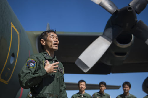 Japanese Air Defense Force Chief Master Sgt. Takanori Konishi, with the 401st Squadron, 1st Tactical Airlift Wing in Japan gives a speech after completing the milestone of 10,000 C-130 Hercules flight hours on June 15, 2016, at Joint Base Elmendorf-Richardson, Alaska. A rare milestone, Konishi has spent a little over 416 days flying in the C-130. (U.S. Air Force photo by Senior Airman James Richardson/Released)