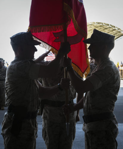 Lt. Col. William Maples (right) passes the flag to Lt. Col. Chad Vaughn (left) as he relinquishes command of the transitioning squadron during a re-designation and change of command ceremony aboard Marine Corps Air Station Yuma, Ariz., June 30. During the ceremony, Marine Attack Squadron (VMA) 211 transitioned to Marine Fighter Attack Squadron (VMFA) 211 making it the first AV-8B Harrier squadron to become an F-35B Lightning II Joint Strike Fighter squadron. (U.S. Marine Corps photo by Lance Cpl. Harley Robinson/Released.)