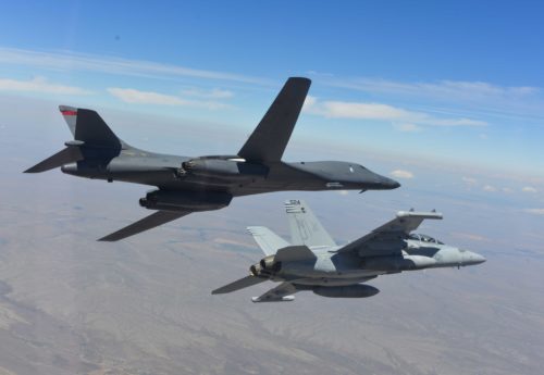 A B-1 bomber and EA-18G Growler bank to the left during a training sortie near Ellsworth Air Force Base, S.D., July 15, 2016. The training focused on further improving joint mission tactics between Air Force and Naval forces. (Courtesy Photo/Released)