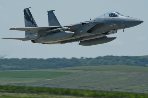 A California Air National Guard F-15C Eagle fighter aircraft assigned to the 194th Expeditionary Fighter Squadron, flies over the flightline during the Romanian air force's 71st Air Base's air show and open house at Campia Turzii, Romania, July 23, 2016. The aviation demonstration took place during the middle of the 194th EFS' six-month long theater security package deployment to Europe in support of Operation Atlantic Resolve, which aims to bolster the U.S.'s continued commitment to the collective security of NATO and dedication to the enduring peace and stability in the region. The unit, comprised of more than 200 CANG Airmen from the 144th Fighter Wing at Fresno ANG Base, Calif., as well as U.S. Air Force Airmen from the 52nd Fighter Wing at Spangdahlem Air Base, Germany, piloted, maintained and supported the deployment of 12 F-15Cs Eagle fighter aircraft throughout nations like Romania, Iceland, the United Kingdom, the Netherlands, Estonia and among others. The F-15Cs took to the skies alongside the 71st AB's MiG-21 fighter aircraft and Puma helicopters for both the airshow, the second engagement of its kind at Campia Turzii under Operation Atlantic Resolve, and the bilateral flight training, also known as Dacian Eagle 2016. (U.S. Air Force photo by Staff Sgt. Joe W. McFadden/Released)