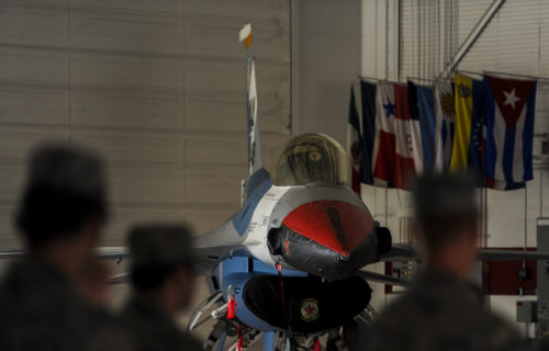 An F-16 Fighting Falcon, assigned to the 64th Aggressor Squadron, with the new “splinter” paint scheme sits in the U.S. Air Force Thunderbird hangar at Nellis Air Force Base, Nev., during the 57th Adversary Tactics Group change of command ceremony Aug. 5, 2016. The new paint scheme for the F-16 will serve as the closest representation of real world threats for pilots who train at Nellis AFB. (U.S. Air Force photo by Airman 1st Class Kevin Tanenbaum/Released)
