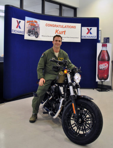 Air Force Capt. Kurt Cloutier is presented with a Harley-Davidson Sportster Forty-Eight during a ceremony at the Moody Air Force Base, Ga., Exchange, Aug. 5, 2016. Cloutier was selected at random from more than 11,400 entrants to the Army & Air Force Exchange Service's Refresh, Win and Ride Sweepstakes. (AAFES photo by Jason Cook)