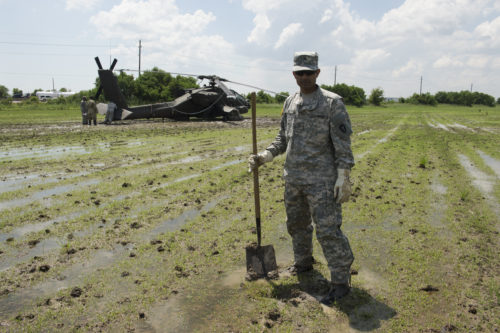 Texas Guardsmen prepare an AH-64D Apache helicopter for recovery operations using a universal maintenance aviation recovery (UMAR) kit, September 1, 2016, following a precautionary landing in a rice paddy in Wallisville, Texas, near Houston, due to mechanical issues. Using the UMAR kit maintenance soldiers from the 1st Battalion, 149th Aviation Regiment (Attack Reconnaissance) waded through six-inch deep mud and worked in a heat index of more than 100 degrees, to ensure a safe and successful sling load recovery mission. (U.S. Army National Guard photo by Capt. Martha Nigrelle)