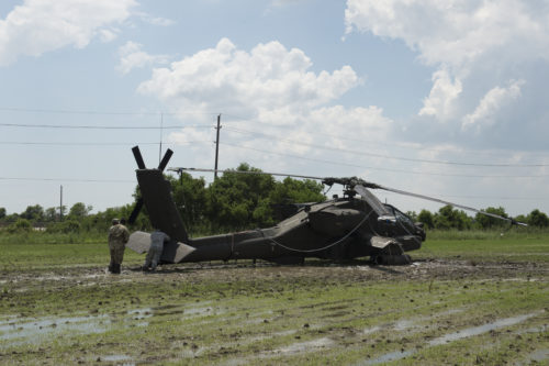 Texas Guardsmen prepare an AH-64D Apache helicopter for recovery operations using a universal maintenance aviation recovery (UMAR) kit, September 1, 2016, following a precautionary landing in a rice paddy in Wallisville, Texas, near Houston, due to mechanical issues. Using the UMAR kit maintenance soldiers from the 1st Battalion, 149th Aviation Regiment (Attack Reconnaissance) waded through six-inch deep mud and worked in a heat index of more than 100 degrees, to ensure a safe and successful sling load recovery mission. (U.S. Army National Guard photo by Capt. Martha Nigrelle)