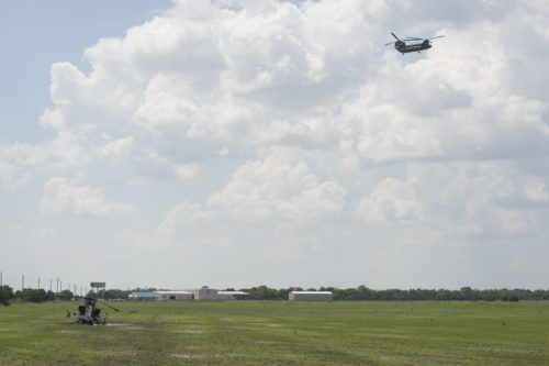 Texas Guardsmen conduct recovery operations of an AH-64D Apache helicopter using a CH-47 Chinook helicopter, September 1, 2016, following a precautionary landing in a rice paddy in Wallisville, Texas, near Houston, due to mechanical issues. Maintenance soldiers from the 1st Battalion, 149th Aviation Regiment (Attack Reconnaissance) waded through six-inch deep mud and worked in a heat index of more than 100 degrees, to ensure a safe and successful sling load recovery mission. (U.S. Army National Guard photo by Capt. Martha Nigrelle)