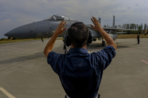 California Air National Guard Staff Sgt. Zechery Blackburn, a 194th Expeditionary Fighter Squadron crew chief, signals to the pilot of an F-15C Eagle fighter aircraft on the flightline at Graf Ignatievo, Bulgaria, Sept. 8, 2016. Four of the squadron’s F-15Cs will conduct joint NATO air policing missions with the Bulgarian air force to police the host nation’s sovereign airspace Sept. 9-16, 2016. The squadron forward deployed to Graf Ignatievo from Campia Turzii, Romania, where they serve on a theater security package deployment to Europe as a part of Operation Atlantic Resolve. (U.S. Air Force photo by Staff Sgt. Joe W. McFadden)