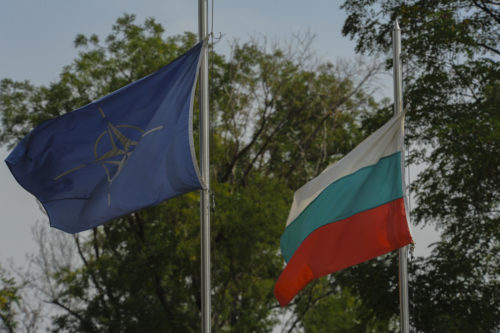 The NATO and Bulgarian flags fly inside the main entrance of Graf Ignatievo, Bulgaria, Sept. 9, 2016.  Four California and Massachusetts Air National Guards’ F-15C Eagle fighter aircraft and approximately 75 Airmen from the 194th Expeditionary Fighter Squadron deployed to Graf Ignatievo, Bulgaria, and will stand ready as interceptors, prepared to quickly react to any violations and infringements for policing of Bulgarian airspace Sept. 9-16, 2016. The squadron forward deployed to Graf Ignatievo from Campia Turzii, Romania, where they serve on a theater security package deployment to Europe as a part of Operation Atlantic Resolve.  (U.S. Air Force photo by Staff Sgt. Joe W. McFadden/Released)