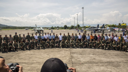 U.S. Marines with Marine All-Weather Fighter Attack Squadron (VMFA(AW)) 225, U.S. Air Force Maj. Gen. Mike Compton, Air National Guard assistant to the commander, Pacific Air Forces, Indonesian Air Force service members and Indonesian Air Vice Marshal Barhim, Air Force Chief Operations Assistant, pose for a photo during a closing ceremony for exercise Cope West 17 at Sam Ratulangi International Airport, Indonesia, Nov. 11, 2016. This fighter-focused, bilateral exercise between the U.S. Marine Corps and Indonesian Air Force is designed to enhance the readiness of combined interoperability between the two nations.