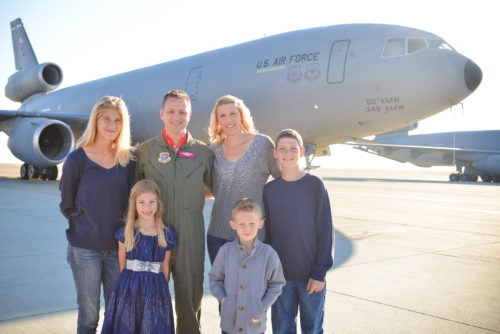 Chief Master Sgt. Rob Wellbaum, 15th Operations Group superintendent, and his family pose in front of a KC-10 Extender.  (Courtesy Photo)