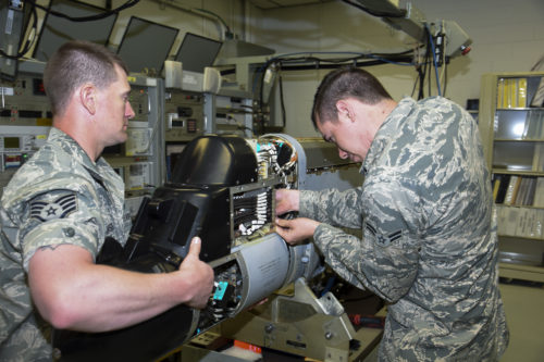 Airman 1st Class Duane Jongeling, 114th Maintenance Squadron electronic countermeasure apprentice, and Staff Sgt. Derek Jaeger, 114th Maintenance Squadron perform a routine maintenance on a electronic warfare pod. These pods are the first line of defense for the 114th Fighter Wing pilots while protecting foreign and domestic airspace. (U.S. Air National Guard photo by Staff Sgt. Duane Duimstra/Released)