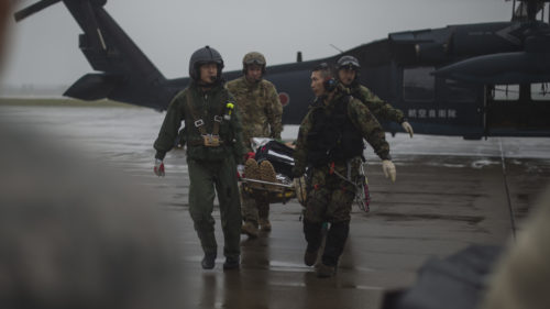 U.S. Air Force Senior Airman Dylan Gorr, a 35th Medical Support Squadron emergency medical technician, and Japan Air Self-Defense Force Akita Prefecture Rescue Squadron pararescuemen transport a simulated injured pilot during exercise Cope Angel 17 at Misawa Air Base, Japan, Aug. 9, 2017. Cope Angel 17 kicked off once an F-16 Fighting Falcon pilot simulated ejection procedures near Draughon Range. Once the exercise began, APRS pararescuemen and their UH-60J Black Hawk located the pilot and transported him back to Misawa AB for medical treatment. This was the first time this type of exercise occured on mainland Japan. (U.S. Air Force photo by Staff Sgt. Deana Heitzman)