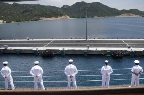 CAM RANH BAY, Vietnam (Oct. 2, 2016)  Sailors, assigned to the submarine tender USS Frank Cable (AS 40), man the starboard-side rails while pulling into Cam Ranh Bay, Vietnam, during a Naval Engagement Activity with the people of Vietnam, Oct. 2. In it's seventh year, NEA Vietnam is designed to foster mutual understanding, build confidence in the maritime domain and strengthen relationships between the U.S. Navy and Vietnam People's Navy and the local community. Frank Cable is one of two forward-deployed submarine tenders and is on a scheduled deployment in the U.S. 7th Fleet area of operations to conduct maintenance and support of deployed U.S. naval force submarines and surface vessels in the Indo-Asia-Pacific region. (U.S. Navy photo by Seaman Alana Langdon)