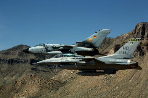 A German air force Tornado and an F-16 Fighting Falcon assigned to the 314th Fighter Squadron, fly in formation together during the last joint flying mission here at Holloman Air Force Base, Aug. 17, 2017. The GAF has entered its final stage of departure, however they will not complete their departure from Holloman AFB until mid 2019. (U.S. Air Force photo by Maj. Bradford "Emcon" Brizek)