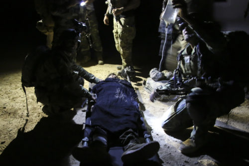 Afghan National Army soldiers with 7th Special Operations Kandak, 215th Corps provide medical care to a notionally wounded soldier during night casualty evacuation training at Camp Shorabak, Afghanistan, Sept. 10, 2017. The event was the third evolution in the past month where U.S. advisors and their Afghan counterparts have completed CASEVAC training, which has focused on developing the Afghans CASEVAC procedures and preparing them for future operations. (U.S. Marine Corps photo by Sgt. Lucas Hopkins)
