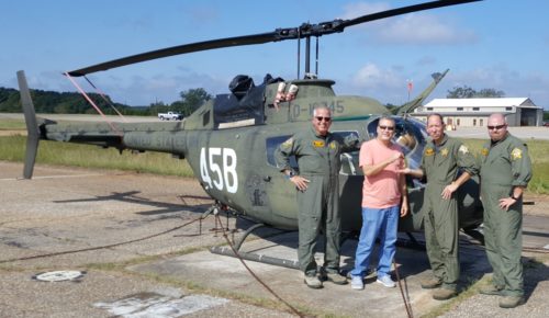 The Aviation Center Logistics Command’s senior aircraft equipment specialist Steven Gatto, second from left, hands over the keys to the last flyable OH-58A Kiowa aircraft at Fort Rucker, Alabama, to Sgt. Randy Phillips at the Aviation Division of the Crown Point, Indiana, Lake County Sheriff's Department. The Kiowa departed Fort Rucker’s Shell Army Airfield on Oct. 17 for its new law enforcement mission with the Lake County Sheriff’s Department. With them are the department’s chief pilot Olaf Tessarzyk, at left, and crew chief Jamieson Hicks. (Courtesy Photo)