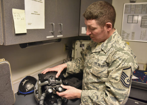 Master Sgt. Josh Sells, 114th Operations Support Squadron aircrew flight equipment specialist, attached a digital eyepiece add-on to a helmet at March Air Reserve Base, CA, Jan. 17. This upgrade highlights the Air Guard's push toward full spectrum readiness by improving current war fighting equipment. (U.S. Air National Guard photo by Tech. Sgt. Luke Olson)